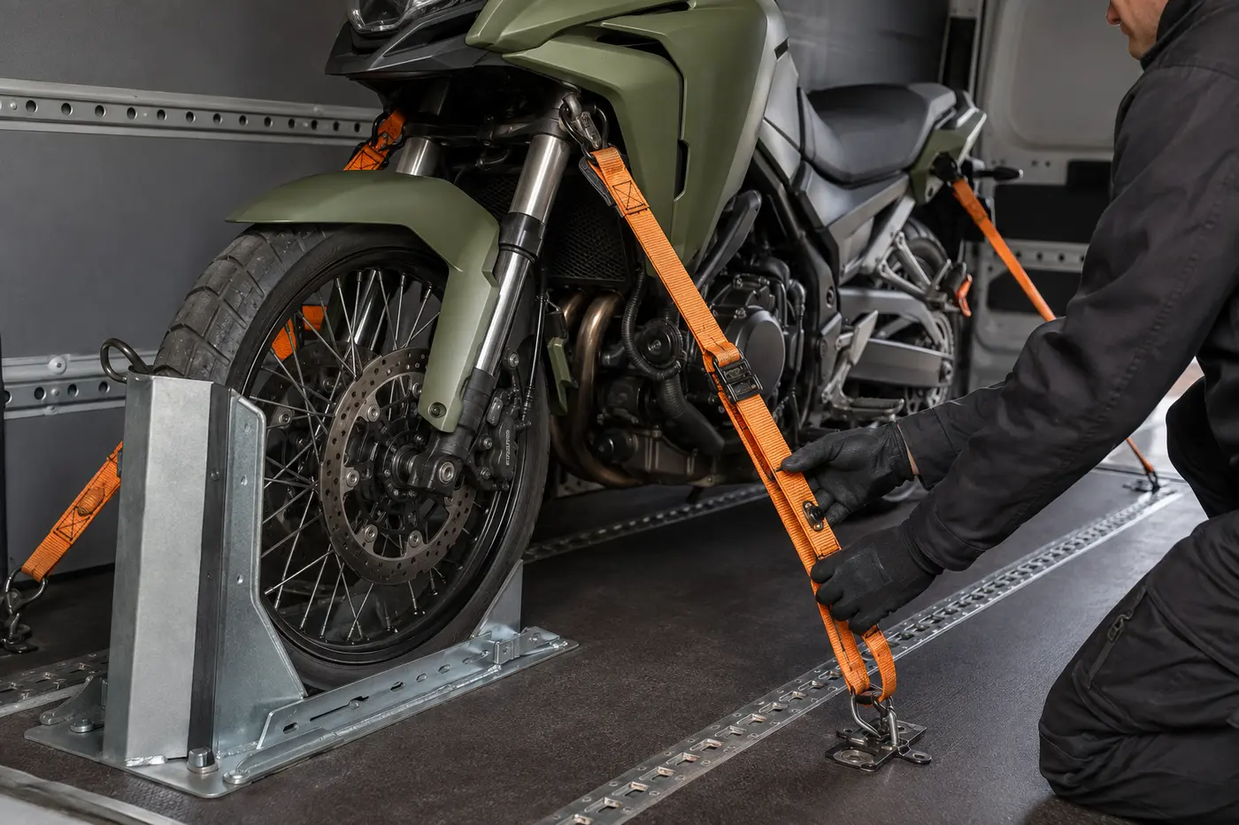 Soft tie-downs and wheel chock securing a recovered motorcycle