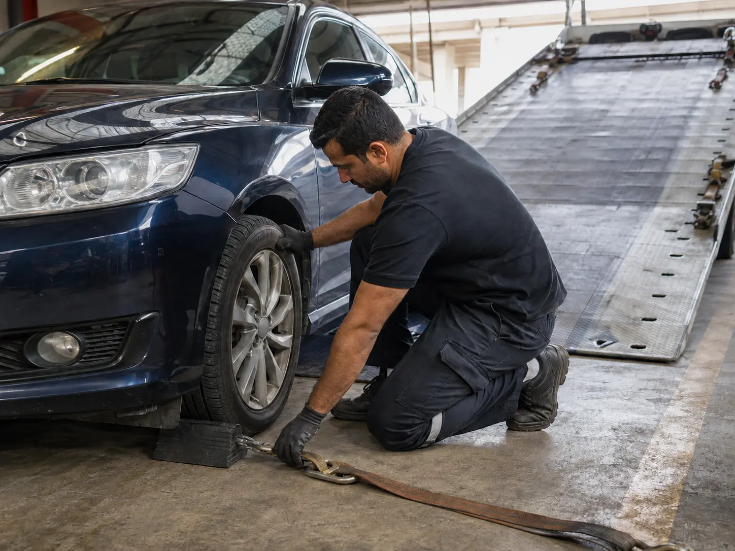 Recovery operator completing a pre-loading vehicle safety check